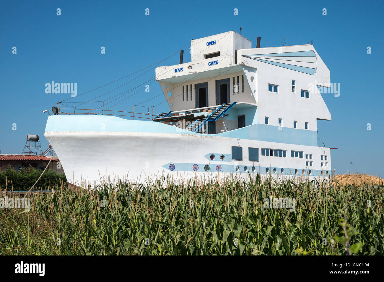Concrete building in the shape of a ship,  destined to be a bar,  on the road between Fieri and Berati, in Albania. Stock Photo