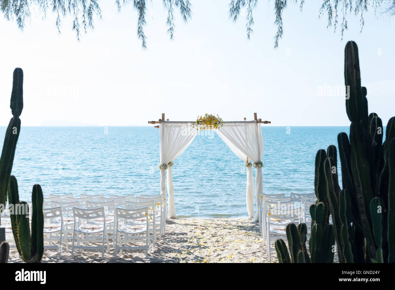 simple style wedding arch and decoration, venue, setup on tropical beach, outdoor beach wedding. Stock Photo