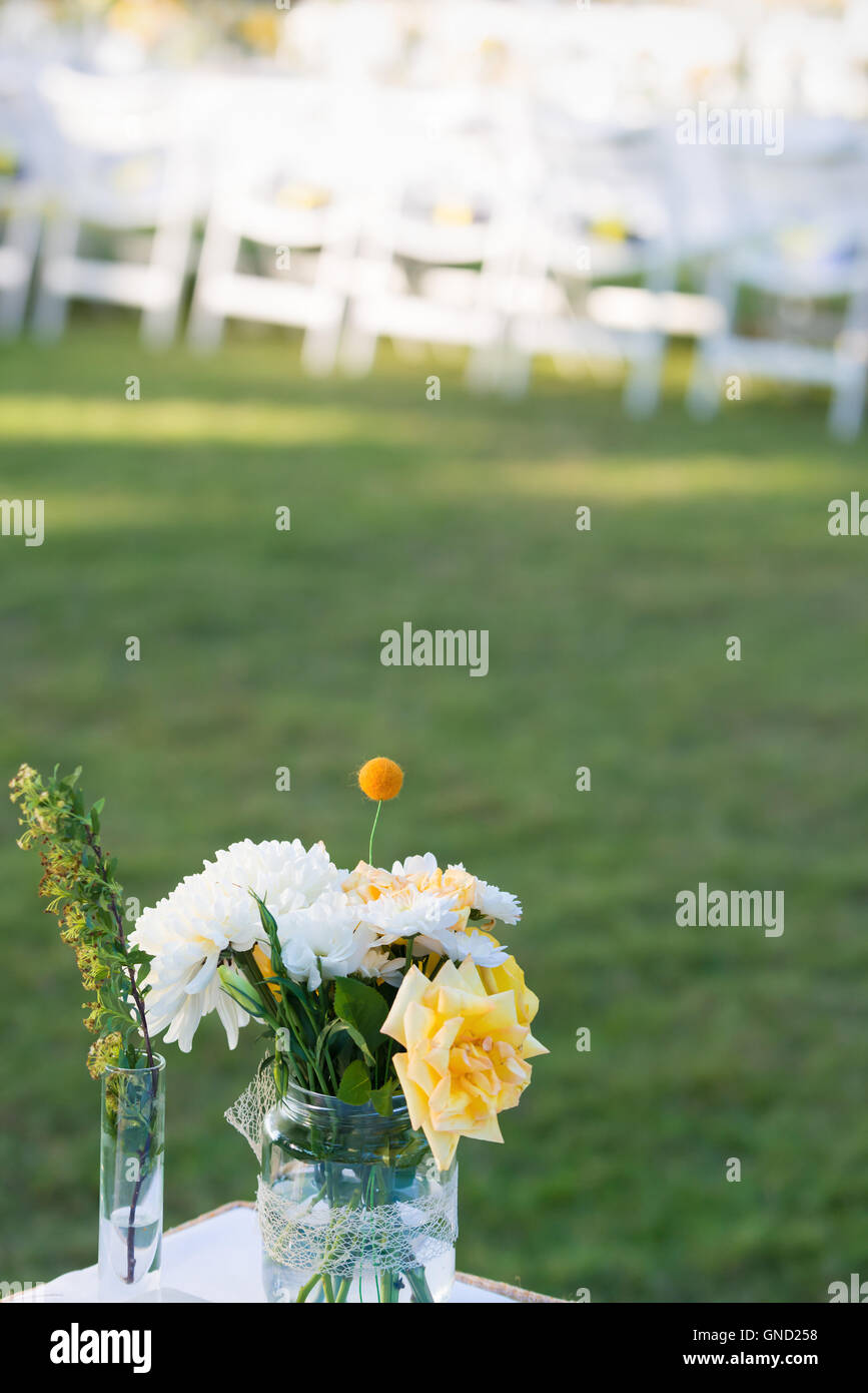 Elegance table set up white, green and yellow flowers theme, selective focus. Stock Photo