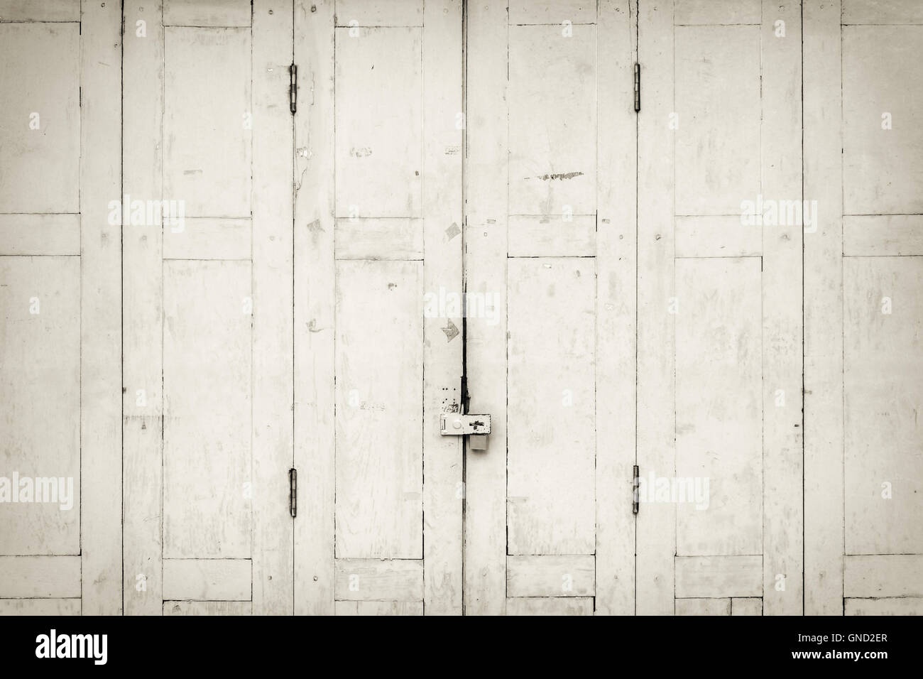 The old grunge folding door closed in B&W. Stock Photo