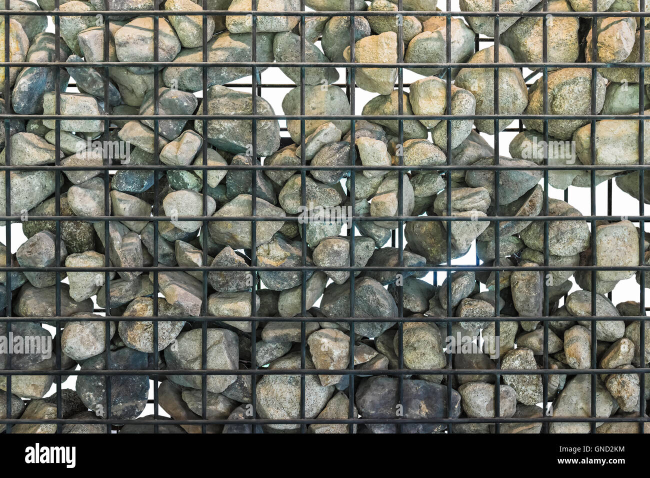 Gabion in close up, Black cage filled with rocks. Isolated. Stock Photo