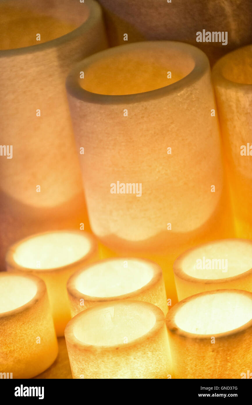Soft focus of candlelight in cylindrical resin used in the ceremony decorations. Stock Photo