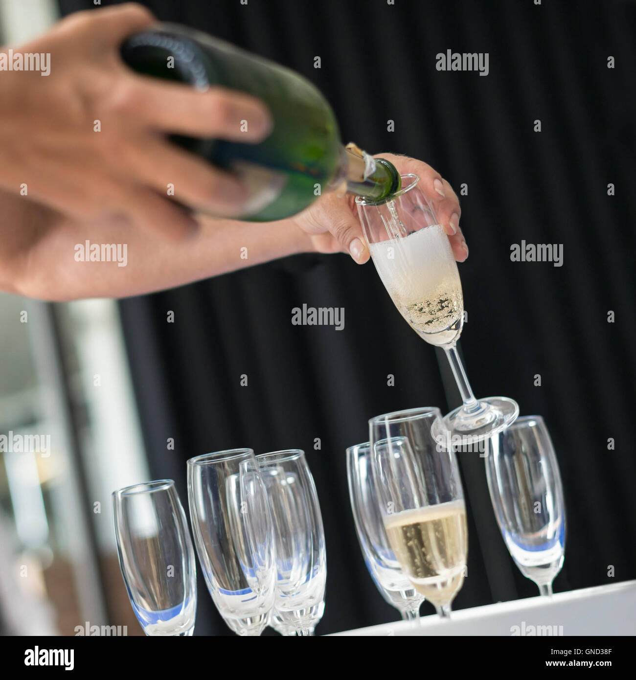 Man pouring champagne into glass, selective focus. Stock Photo