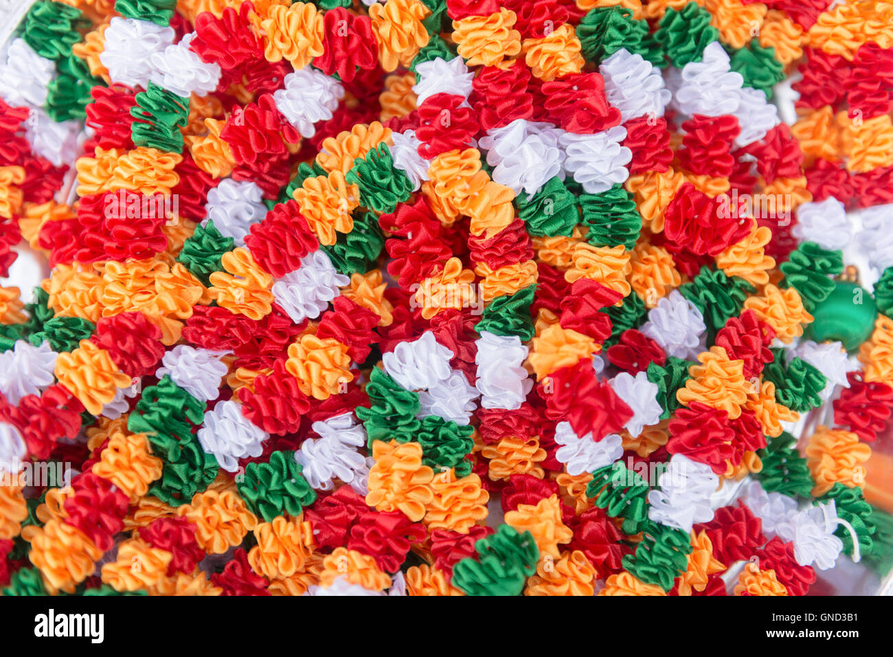Indian traditional culture stuff from colourful fabrics white red green orange for holy religious ritual. Useful for background. Stock Photo