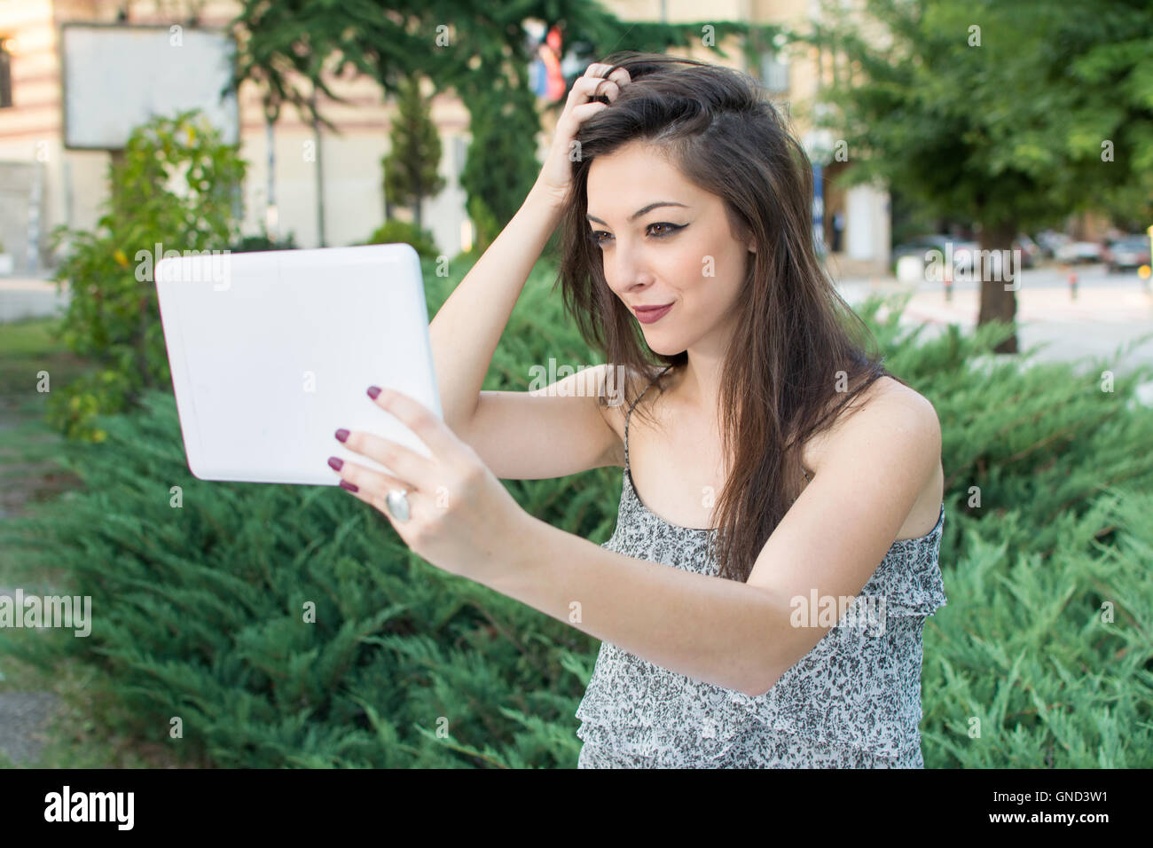 Young woman taking selfie with a tablet device Stock Photo