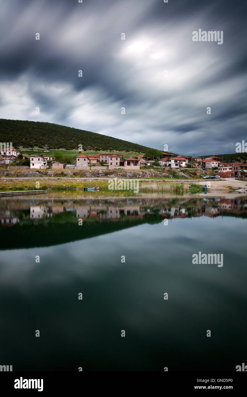 Small greek village by Lake Prespa. Long exposure shot with dramatic sky Stock Photo