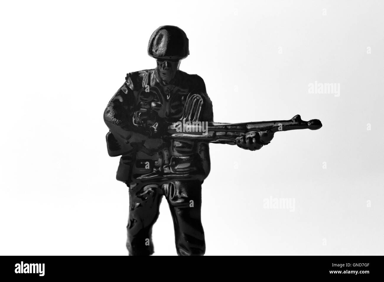 Dramatic toy army soldier marching to battle black and white image Stock Photo