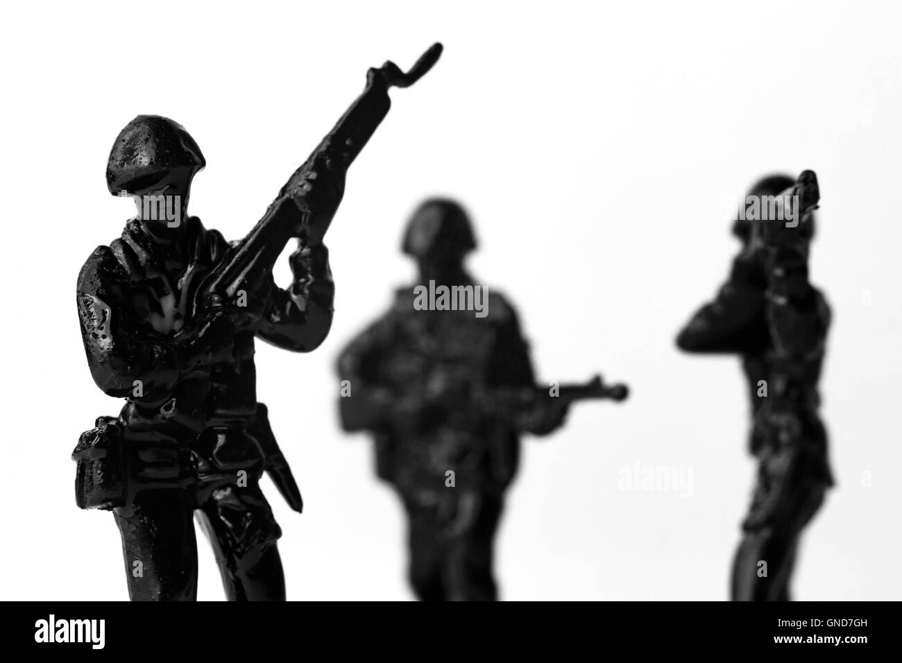 Dramatic toy army soldiers lined up for battle in black and white image Stock Photo