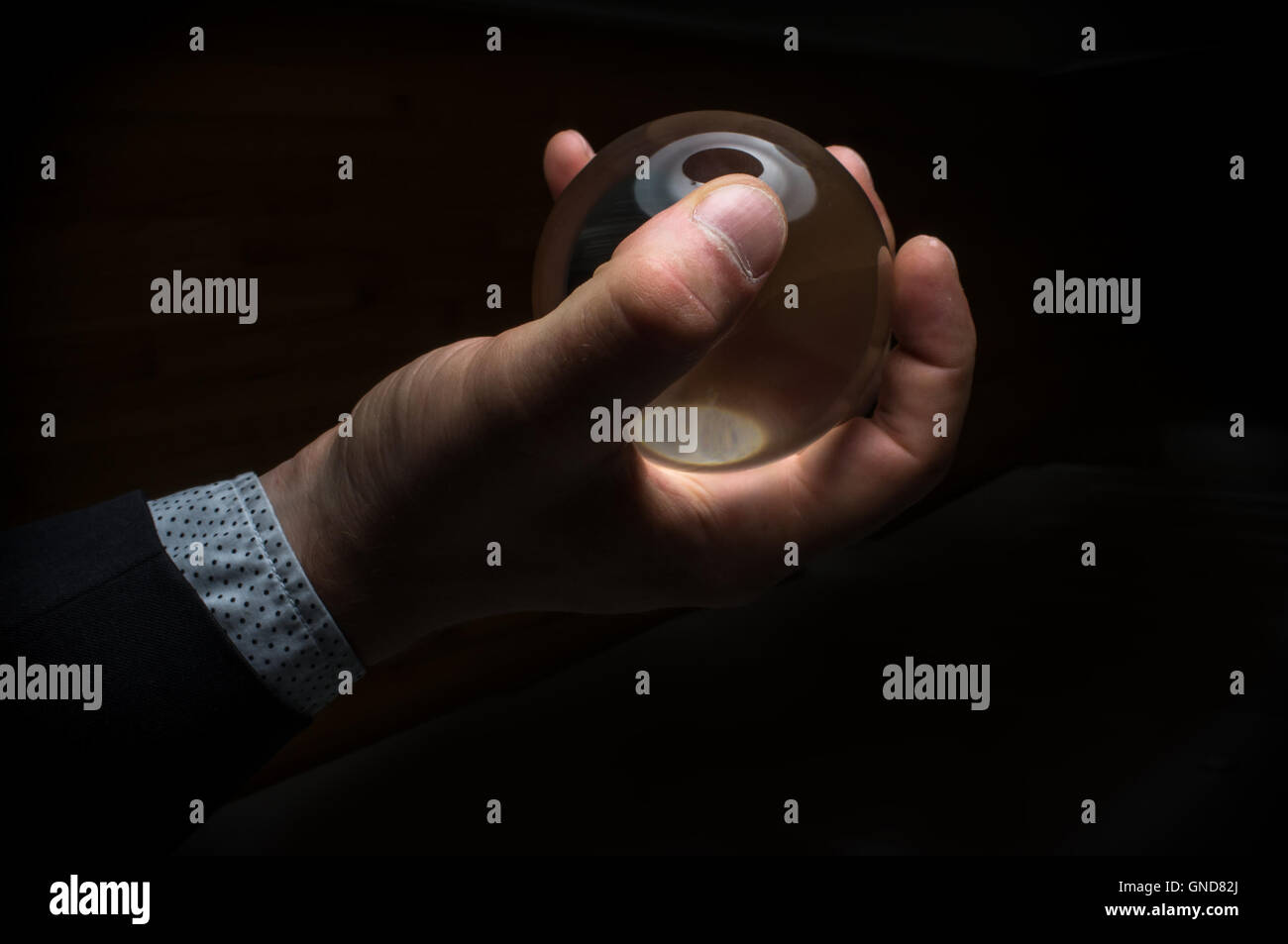 Holding magic crystal ball in fortune teller business background Stock ...