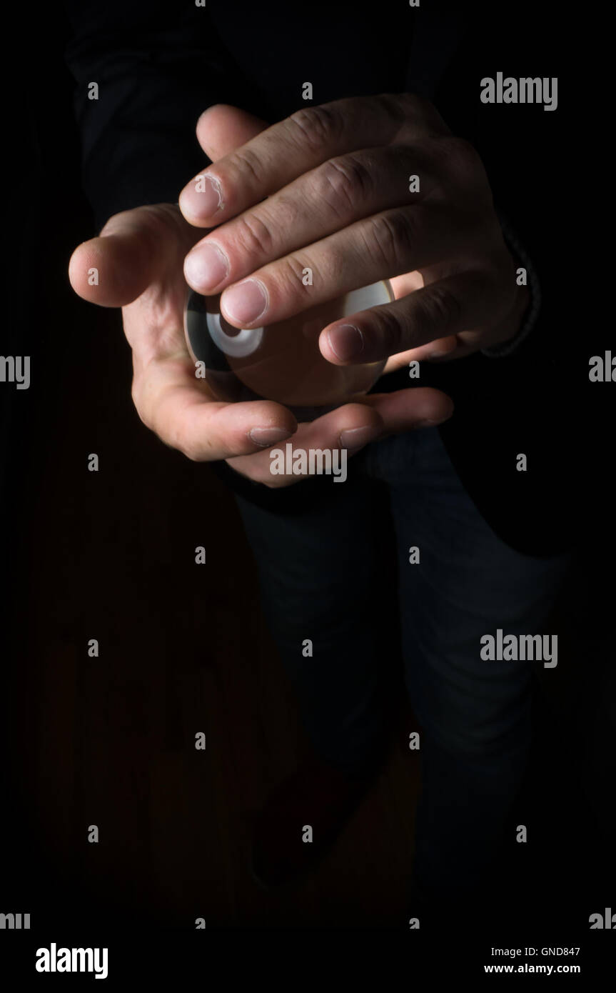 Holding magic crystal ball in fortune teller business background Stock