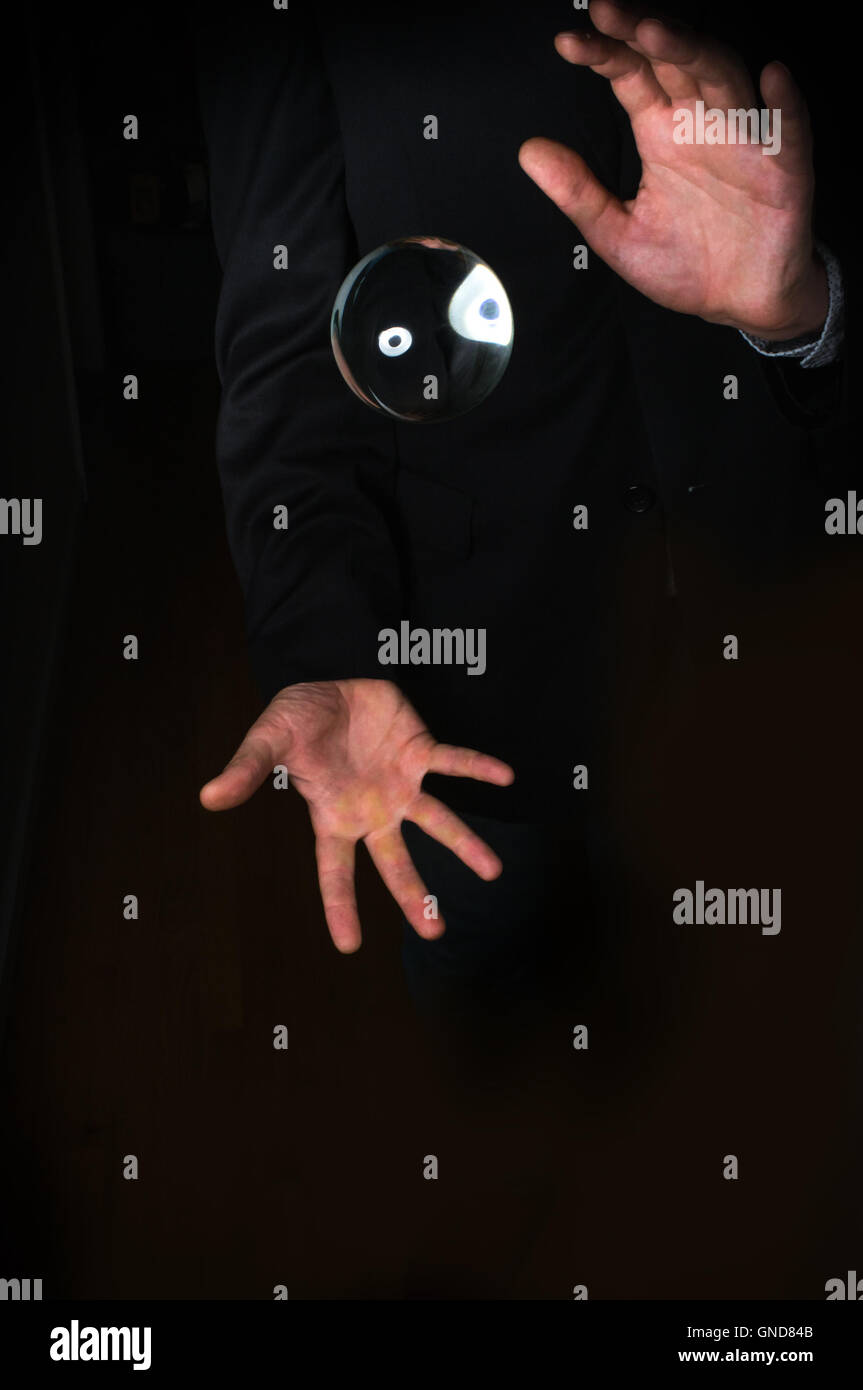 Holding magic crystal ball in fortune teller business background Stock