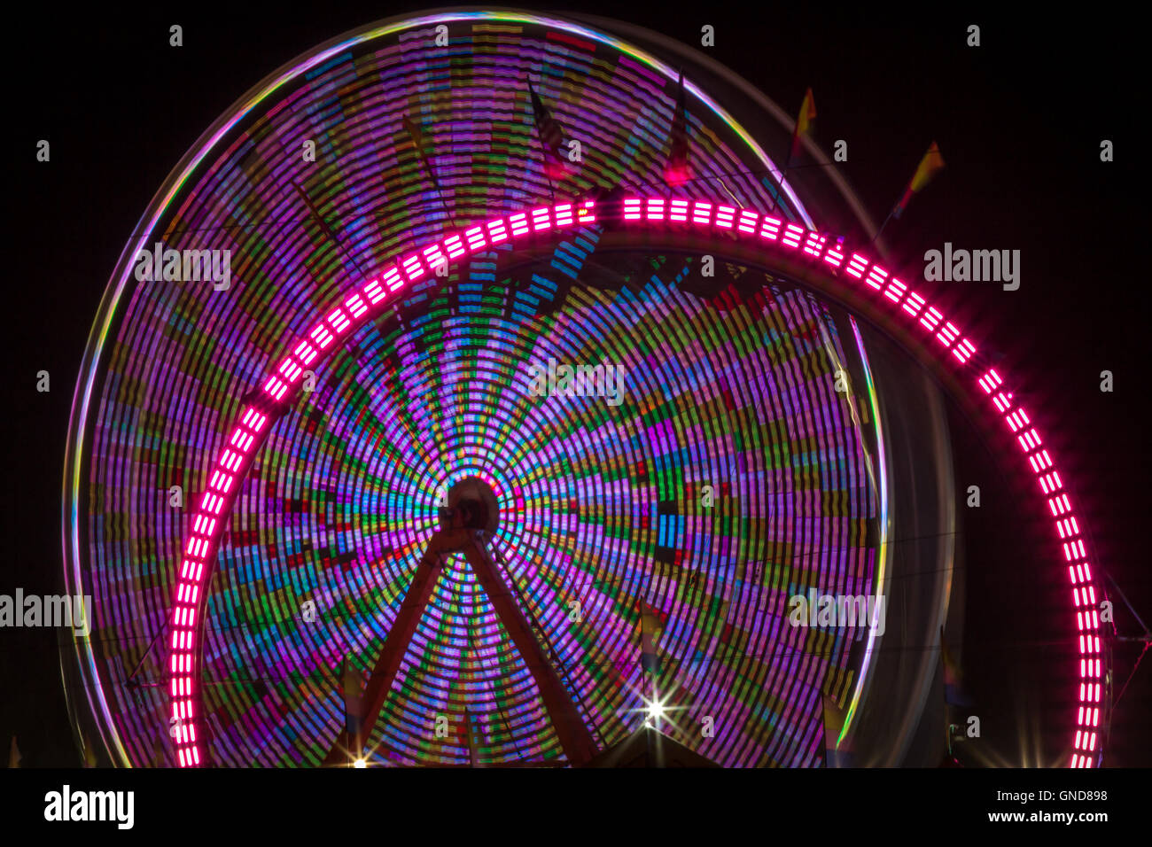 Summer carnival ferris wheel at night with light blur time lapse Stock ...