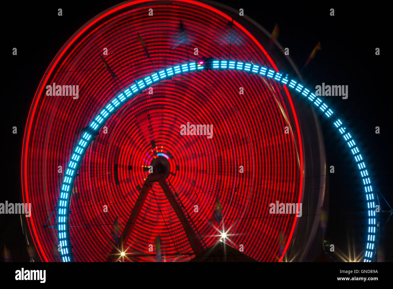 Summer carnival ferris wheel at night with light blur time lapse Stock ...
