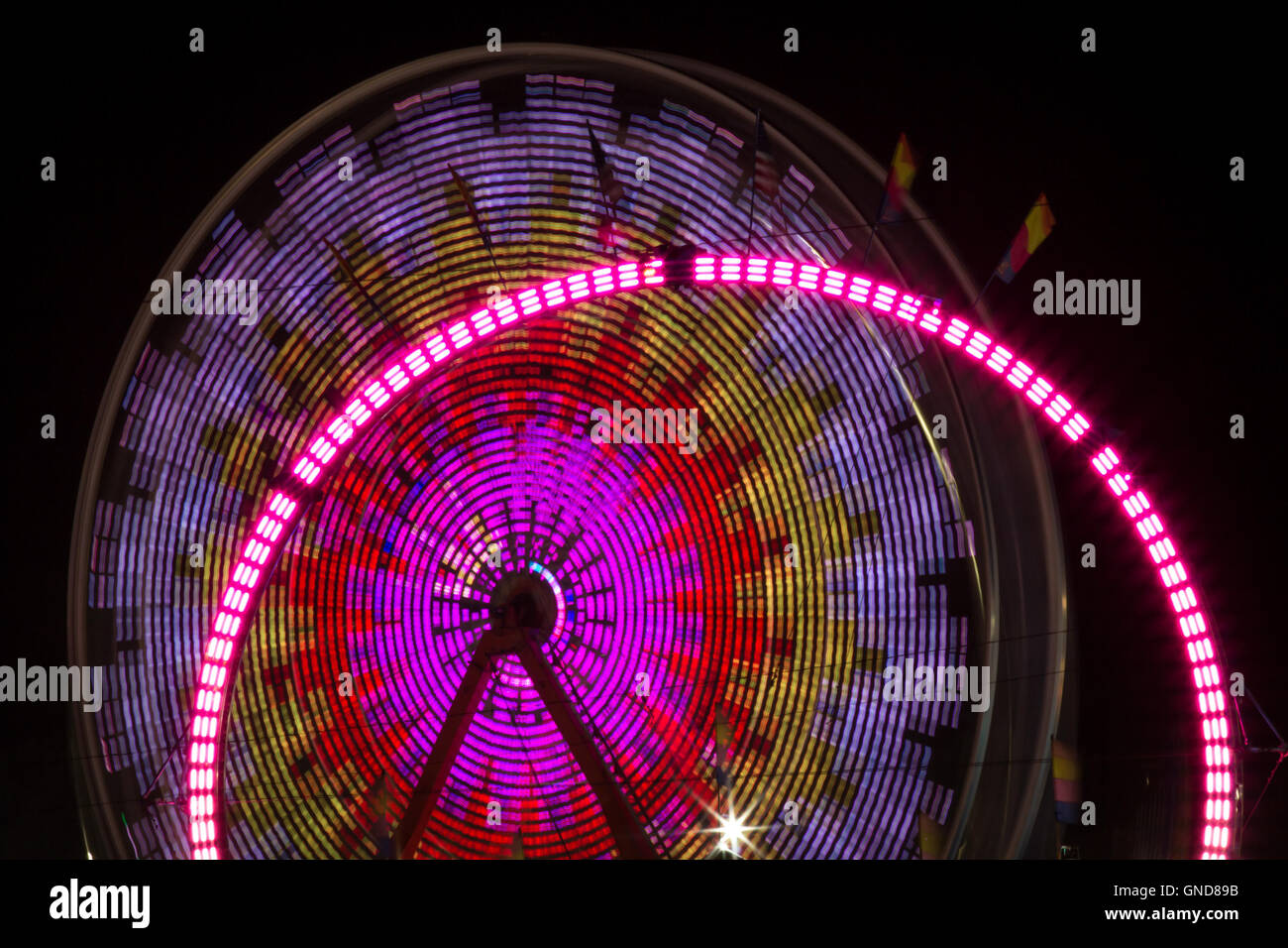 Summer carnival ferris wheel at night with light blur time lapse Stock ...