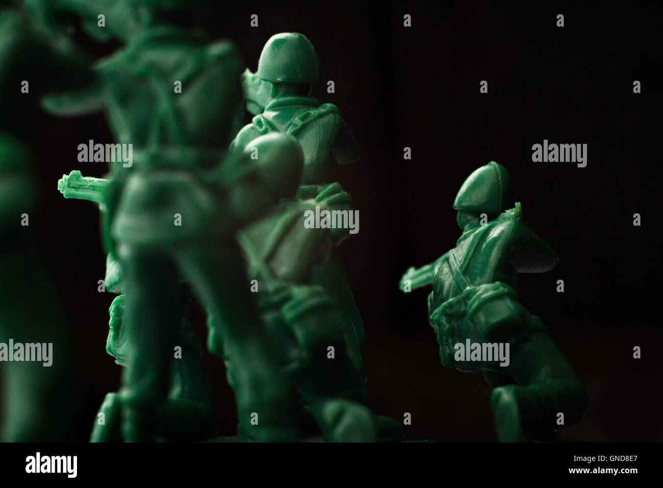 Dramatic green toy army soldiers lined up for battle Stock Photo
