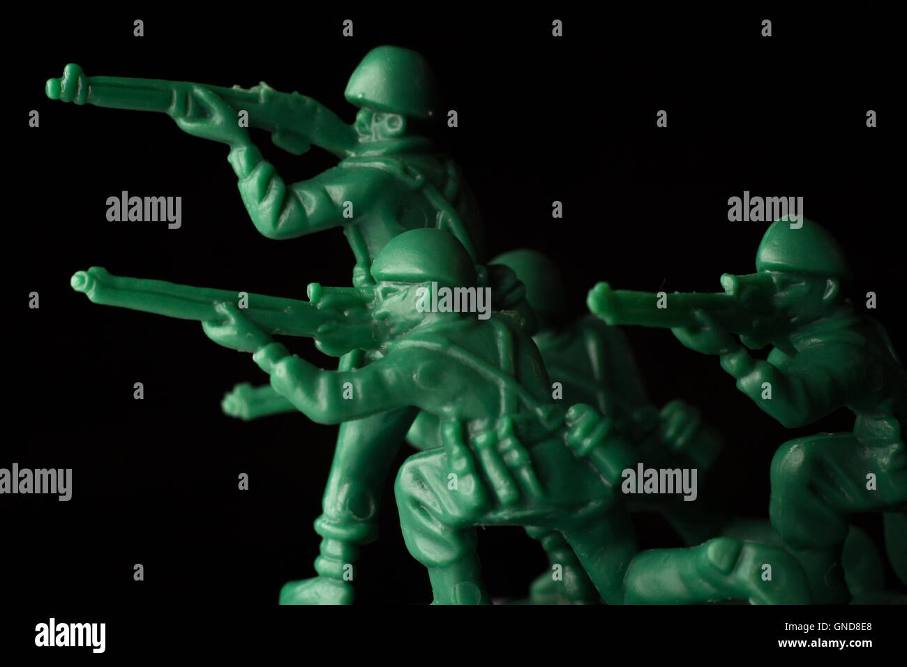 Dramatic green toy army soldiers lined up for battle Stock Photo