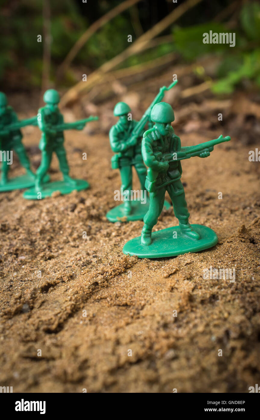 Green toy soldiers march forward ready for battle Stock Photo