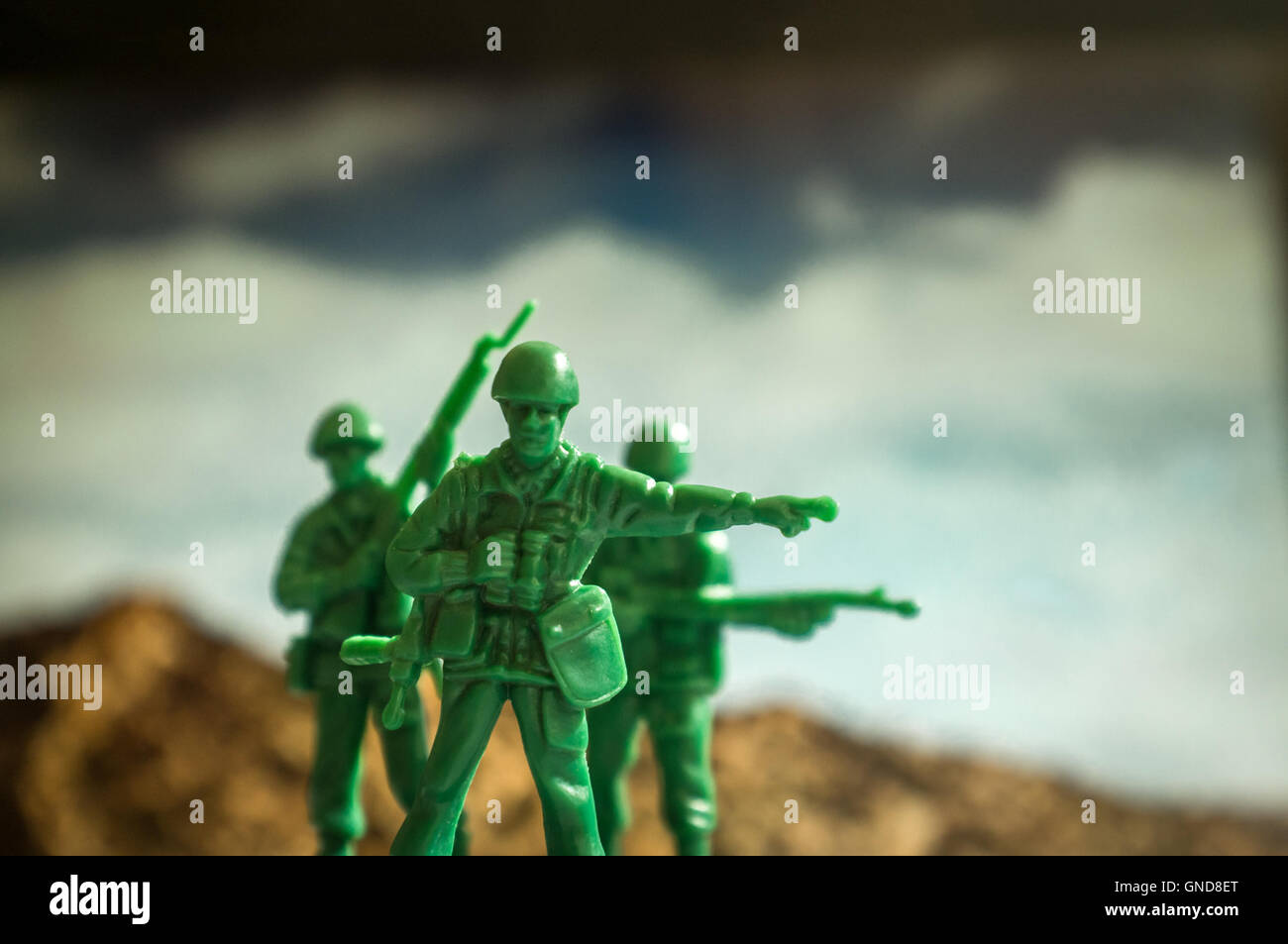 Green toy soldiers with mountaintops the lookout points the way Stock Photo