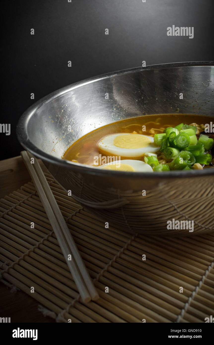 Korean cuisine ramen noodle soup with mushrooms and hard boiled eggs