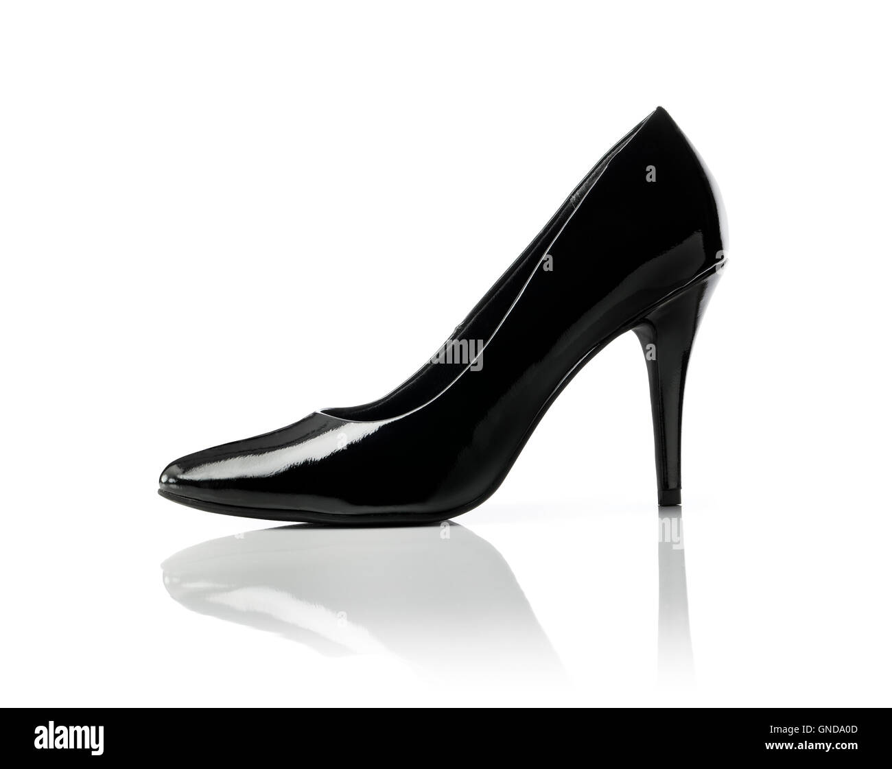 Black shiny stiletto heel women's pump shoe on white. Stock Photo