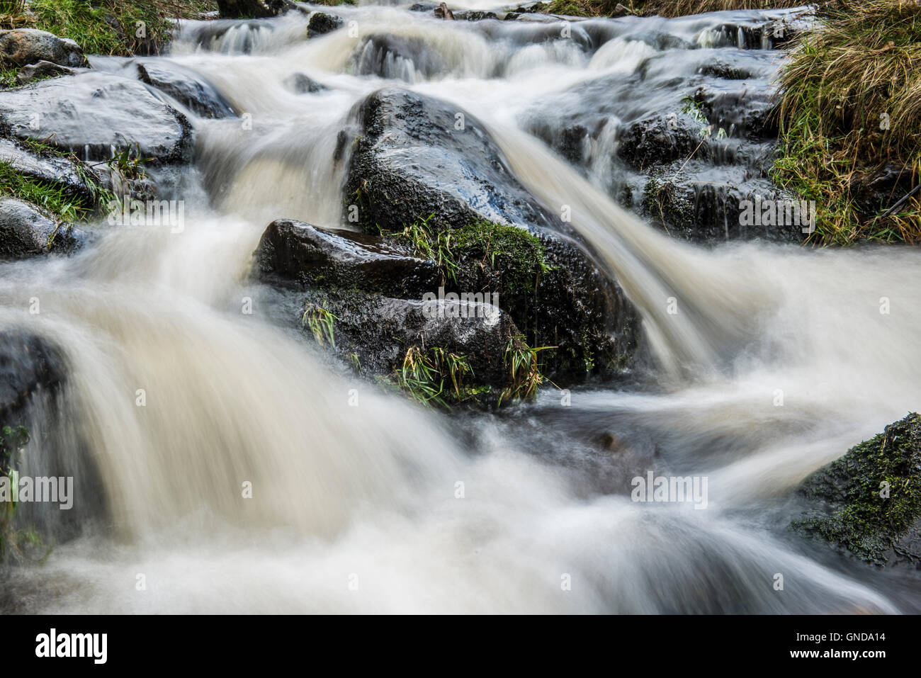 Long exposure shot of Grindsbrook waterfalls in Edale, Derbyshire Stock Photo