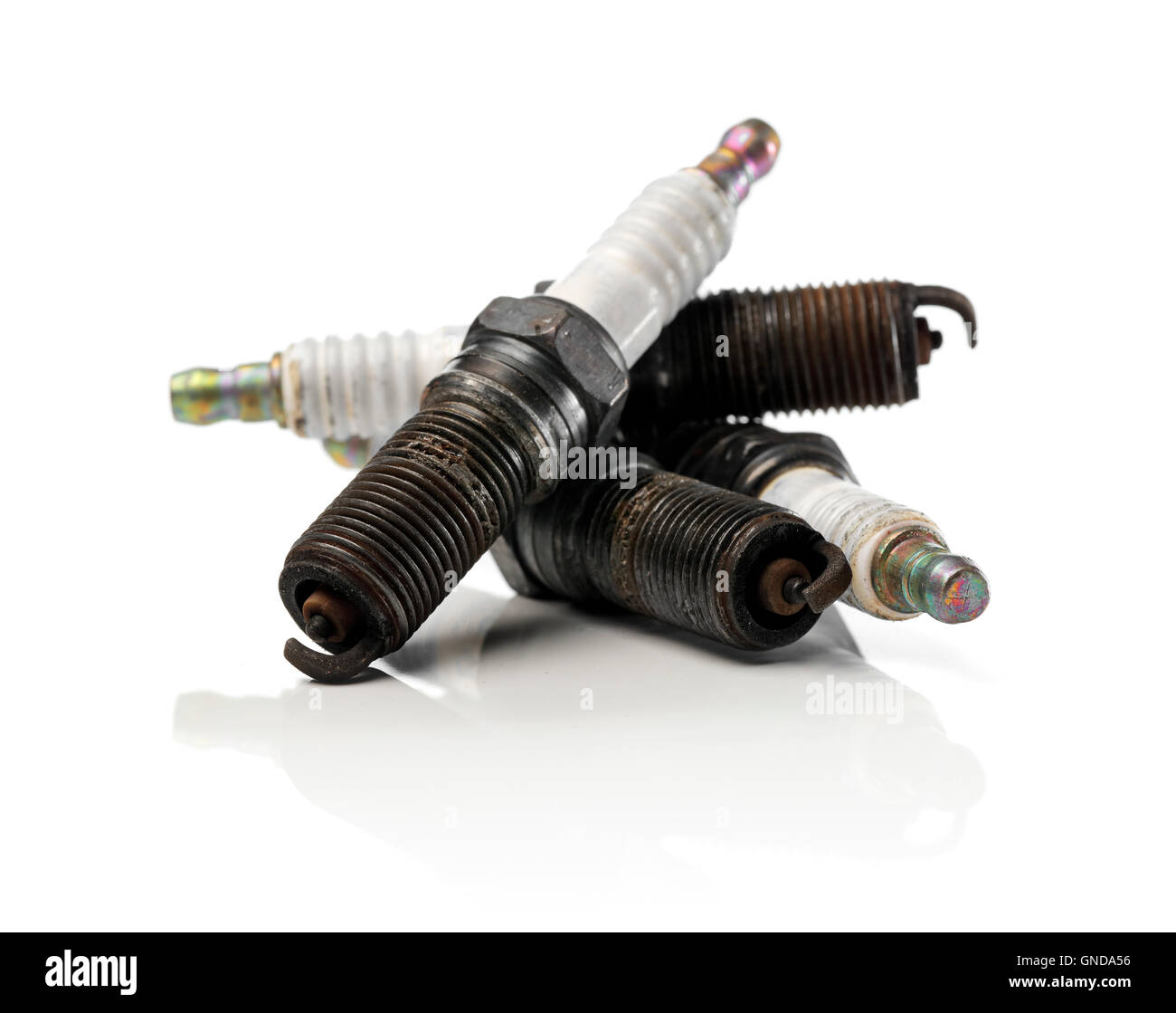 Four old used and dirty spark plugs from a car Stock Photo Alamy