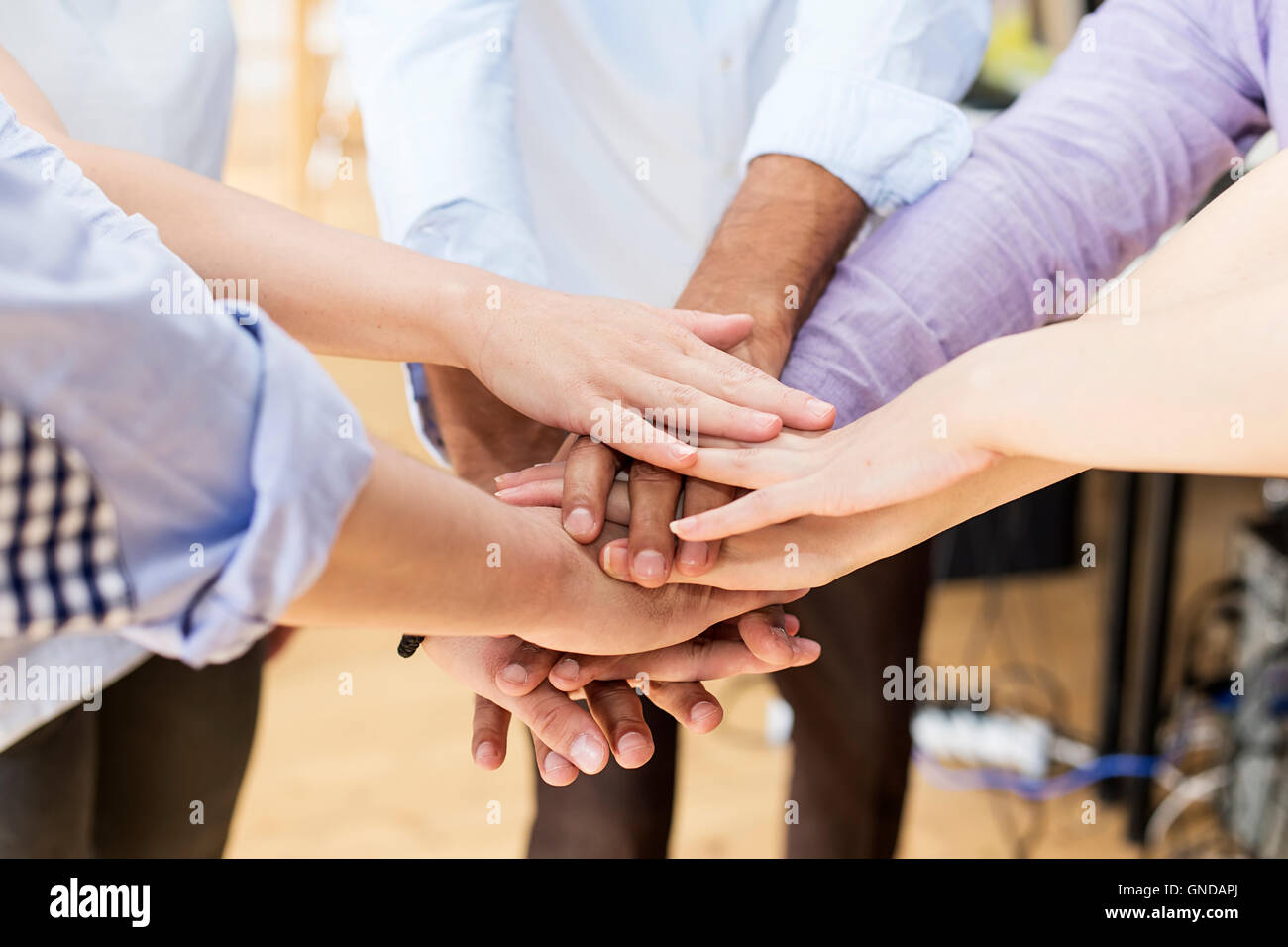 Close up view at group of hands holding together Stock Photo
