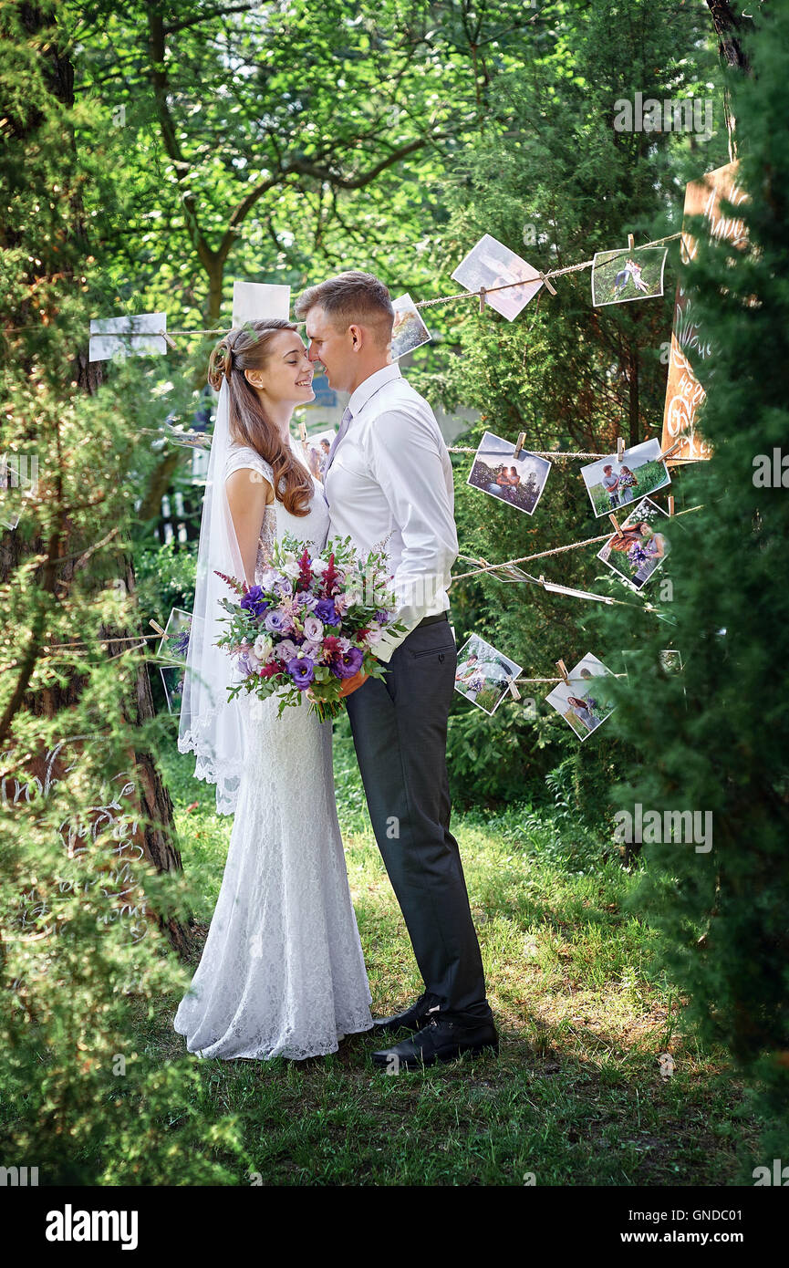 bride and groom are in the blossoming spring garden Stock Photo