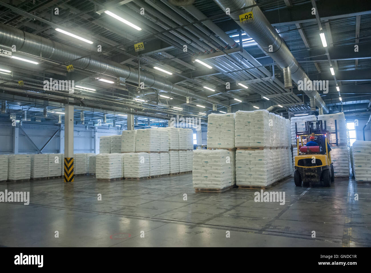 Forklift truck loads pallets with finished goods Stock Photo