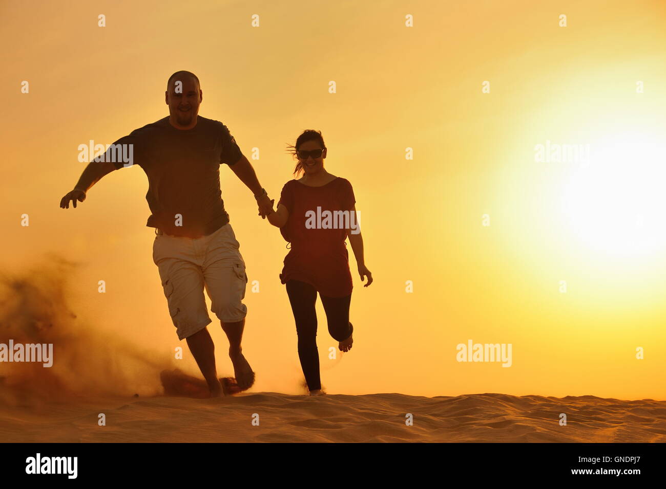 couple enjoying the sunset Stock Photo - Alamy