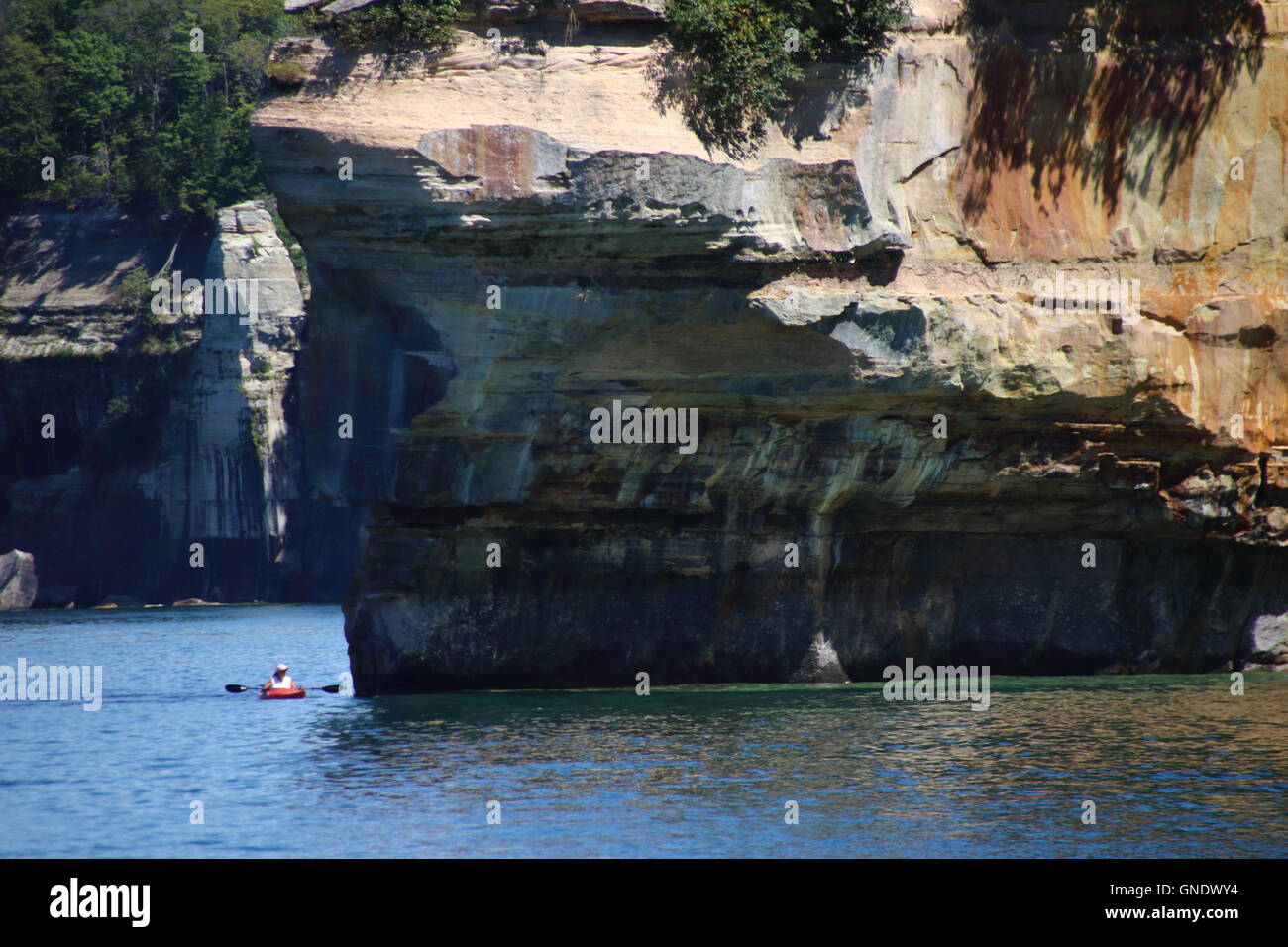 Kayaker at Battleship Rocks at  Pictured Rocks National Park, MI, USA Stock Photo