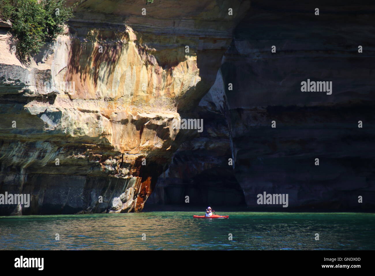 Kayaker in front of Lover's Leap arc at Pictured Rocks National Park, MI, USA Stock Photo