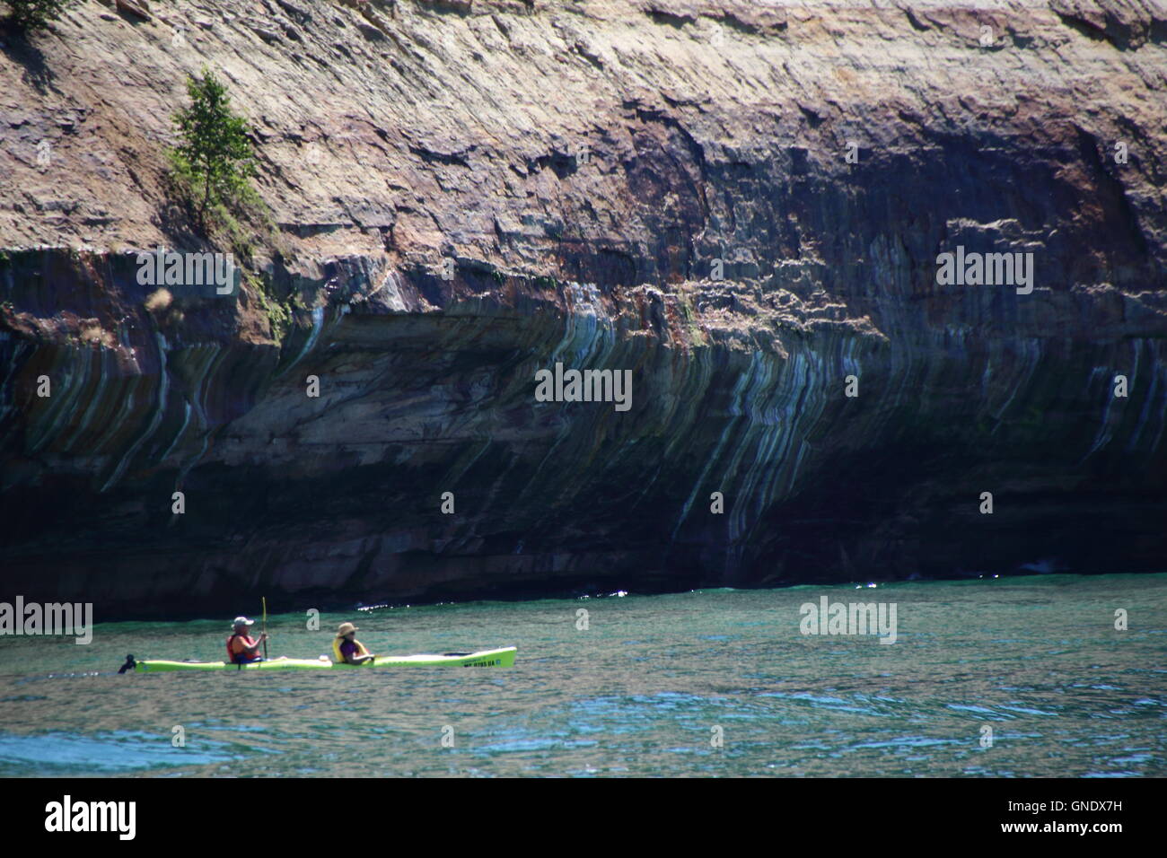 Double kayak at Pictured Rocks National Park, MI, USA in front of colored stone formations on coast of Lake Superior. Stock Photo