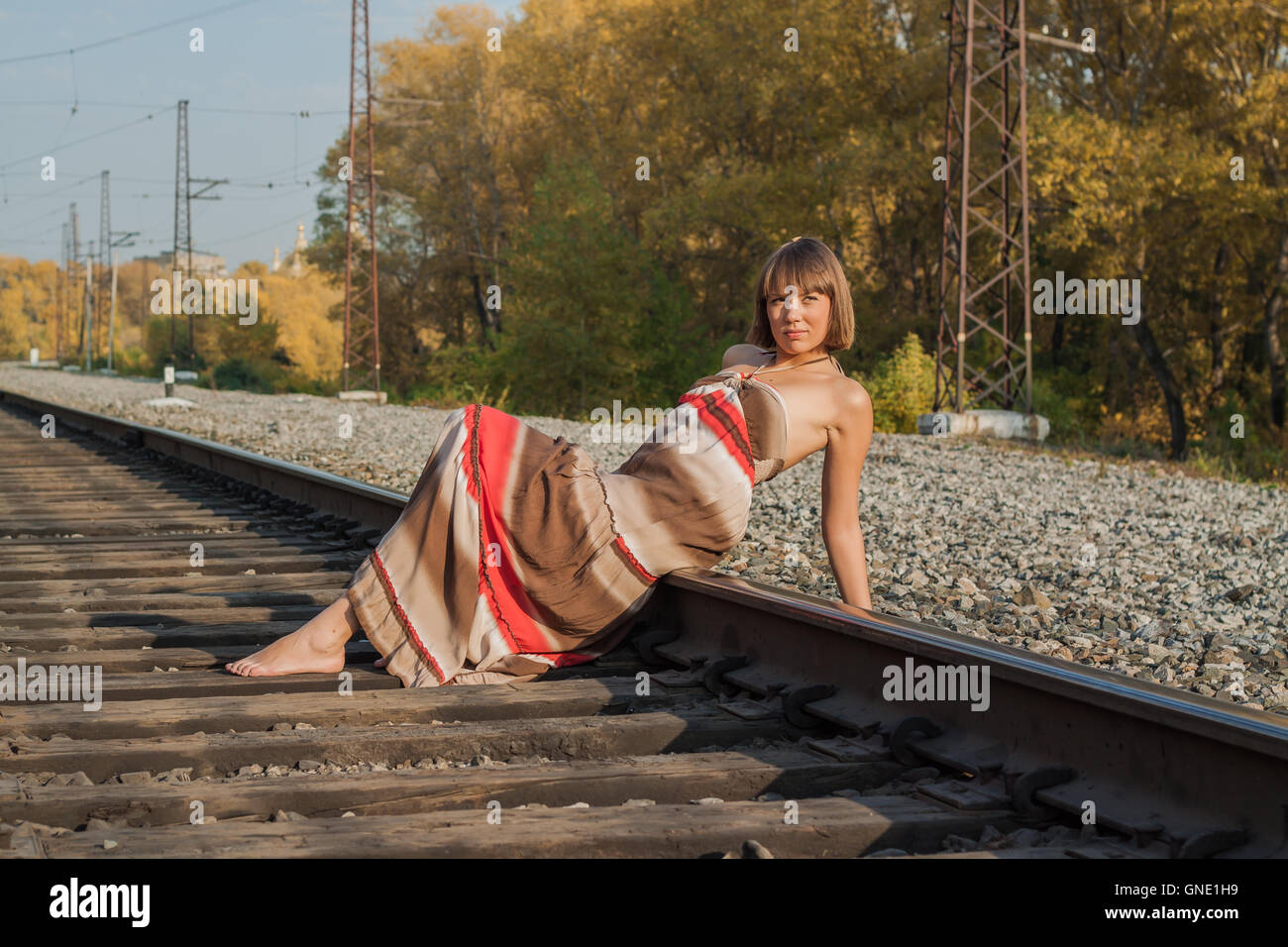 Beautiful girl sitting on railroad track Stock Photo Alamy