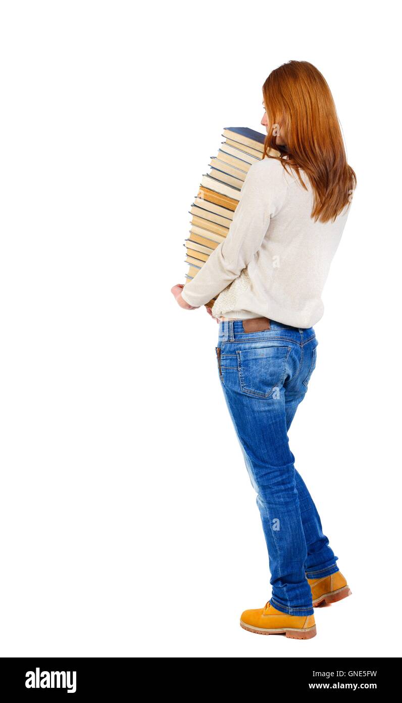 Girl carries a heavy pile of books. back view Stock Photo - Alamy