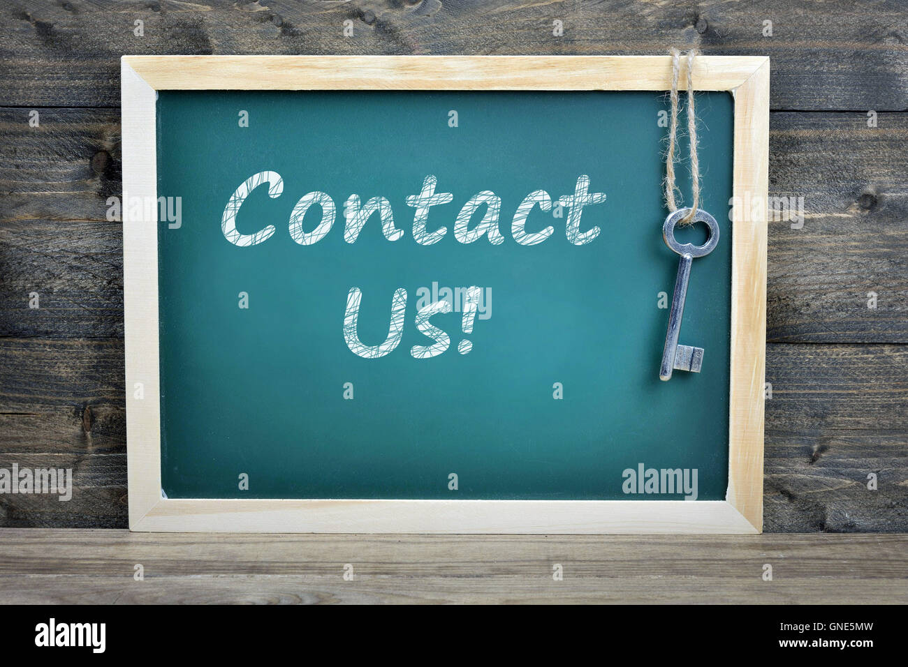 Contact Us text on school board and old key Stock Photo