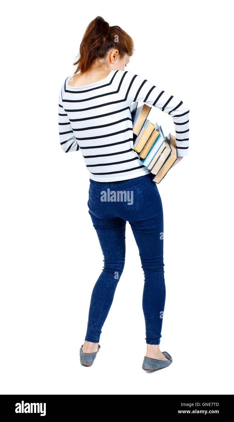 Girl carries a heavy pile of books. back view Stock Photo - Alamy