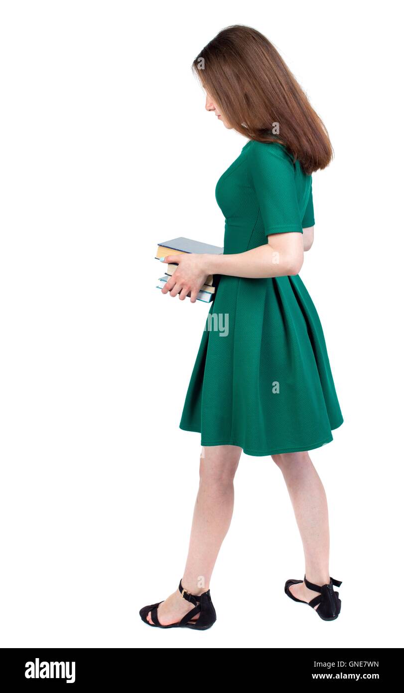 Girl carries a heavy pile of books. back view Stock Photo - Alamy