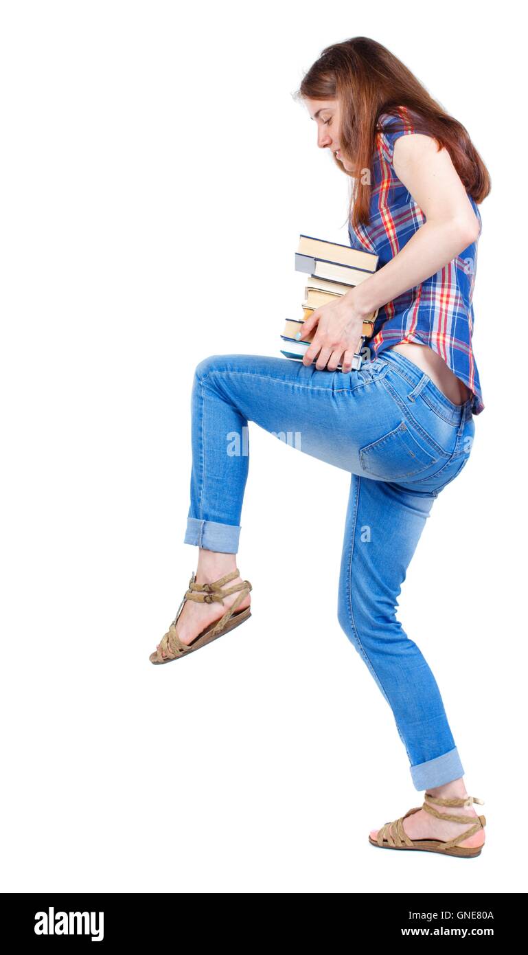 Girl carries a heavy pile of books. back view Stock Photo - Alamy