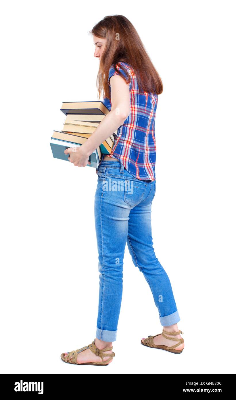 Girl carries a heavy pile of books. back view Stock Photo - Alamy