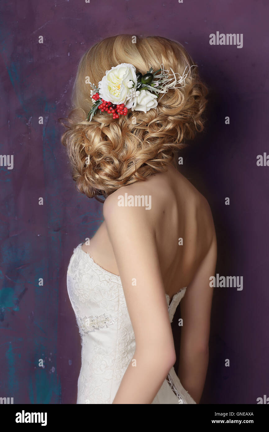 Styling hair with flowers. Portrait of the bride. Hairstyle. Stock Photo