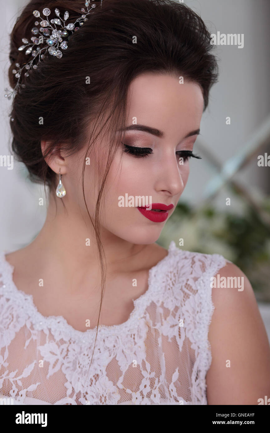 Bride portrait. Wedding makeup, red lips. Clip in hair. Stock Photo