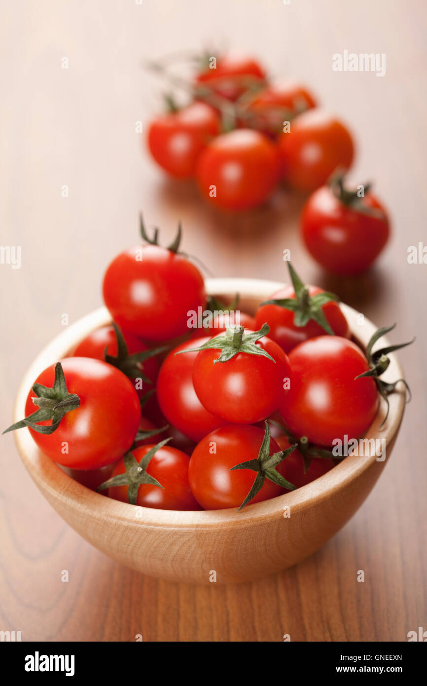 ripe tomatoes in wooden bowl Stock Photo - Alamy