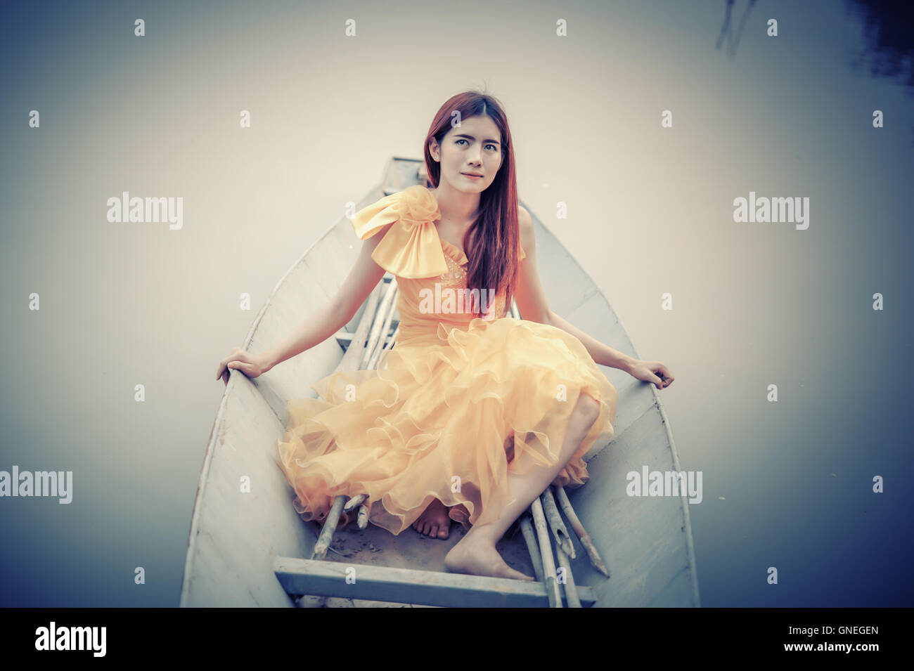 Portrait of Asia Beautiful woman in yellow dress sitting on boat Stock ...