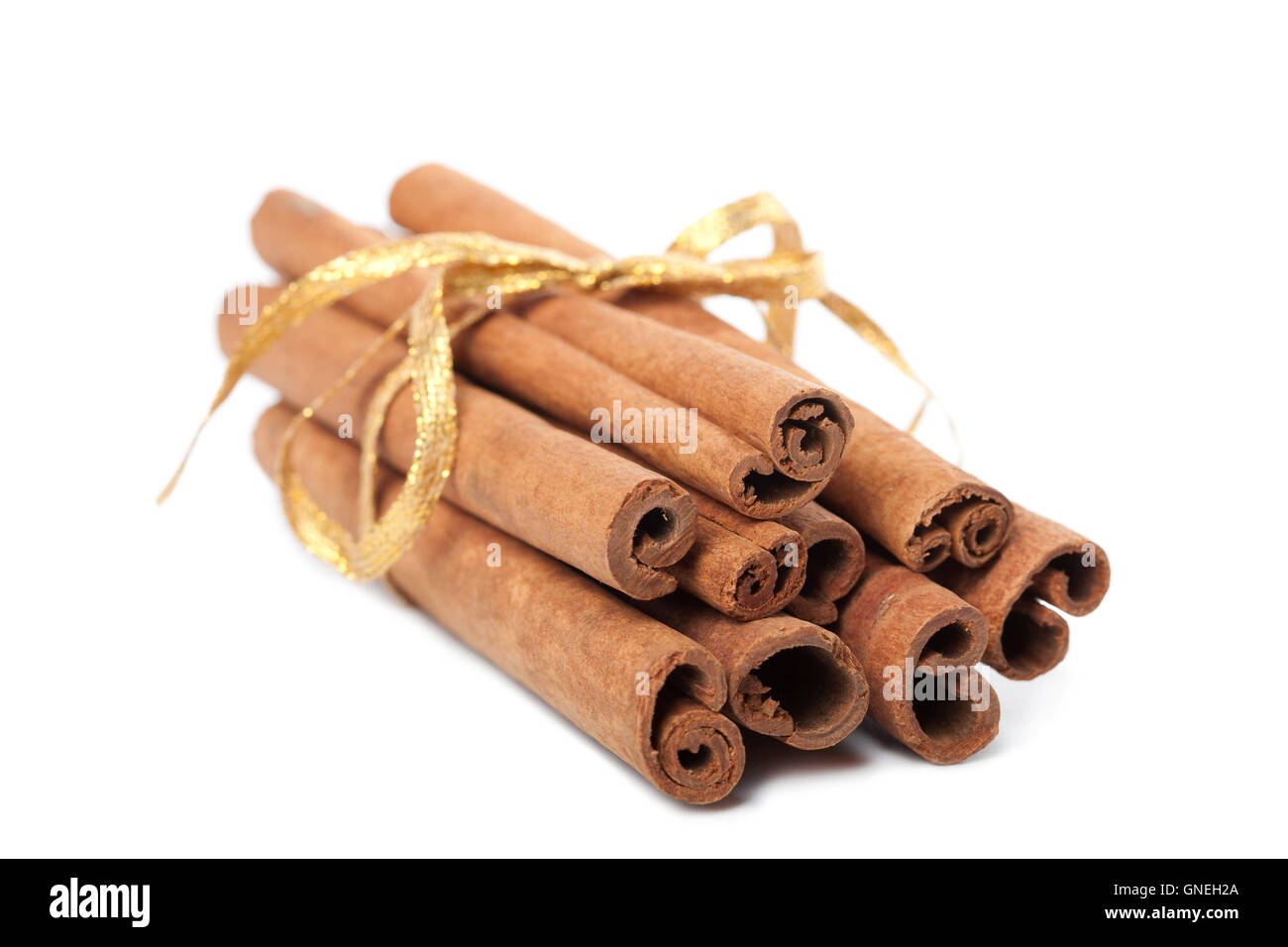 cinnamon with golden ribbon isolated Stock Photo Alamy