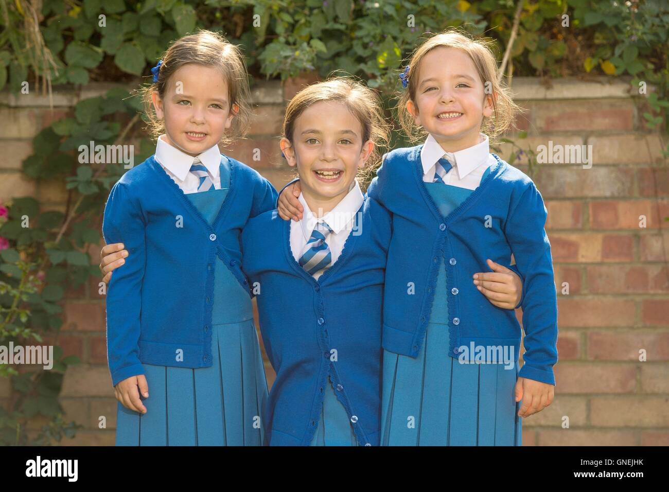 Rosie (left) and Ruby Formosa, from London, with their elder sister Lily (centre). The twins, who were born joined at the abdomen and shared part of the intestine, are due to start school in September. Stock Photo