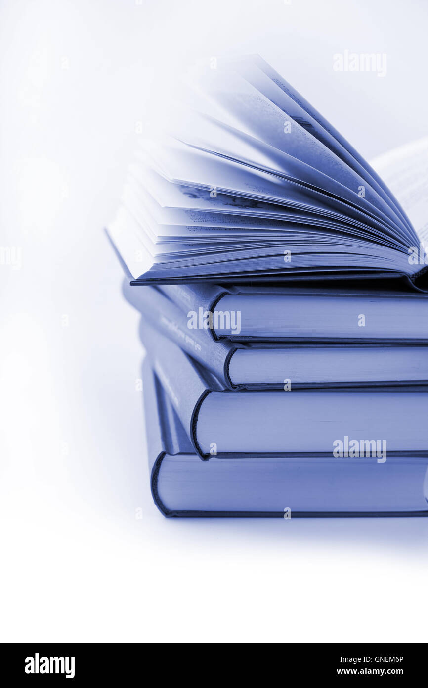 pile of books with one book open Stock Photo