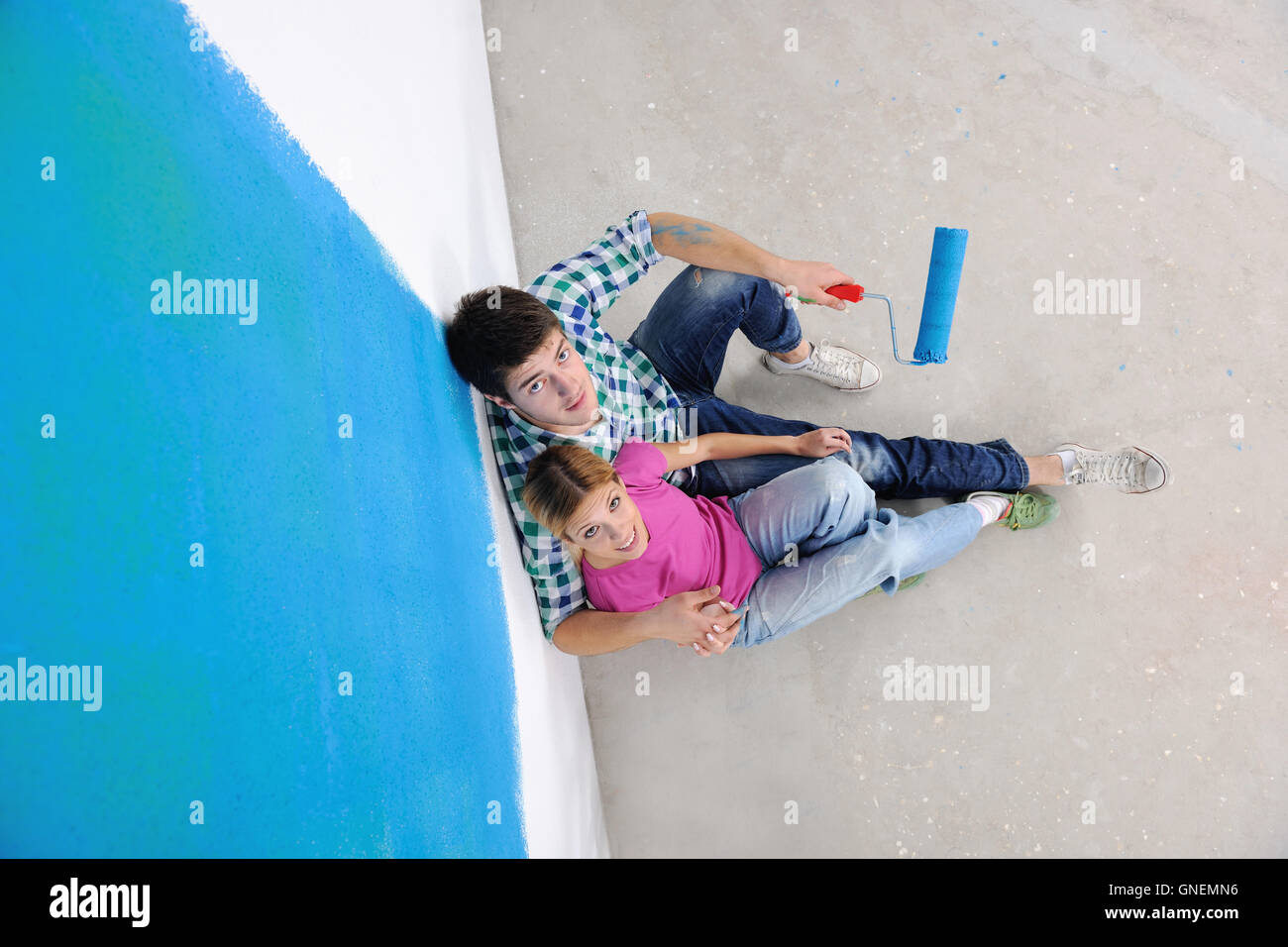 happy young cople relaxing after painting in new home Stock Photo Alamy