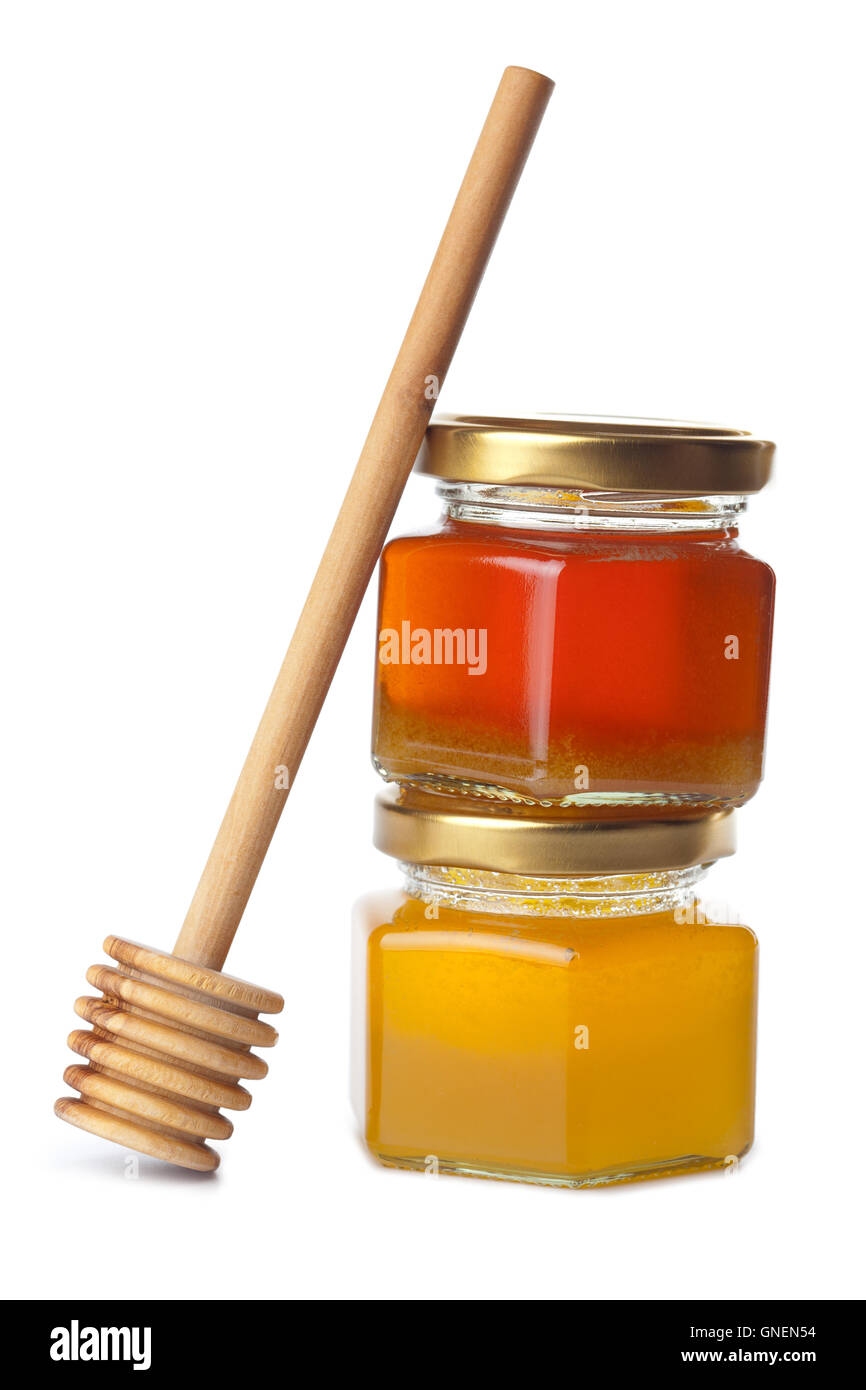 honey in bottles and wooden dipper isolated Stock Photo Alamy