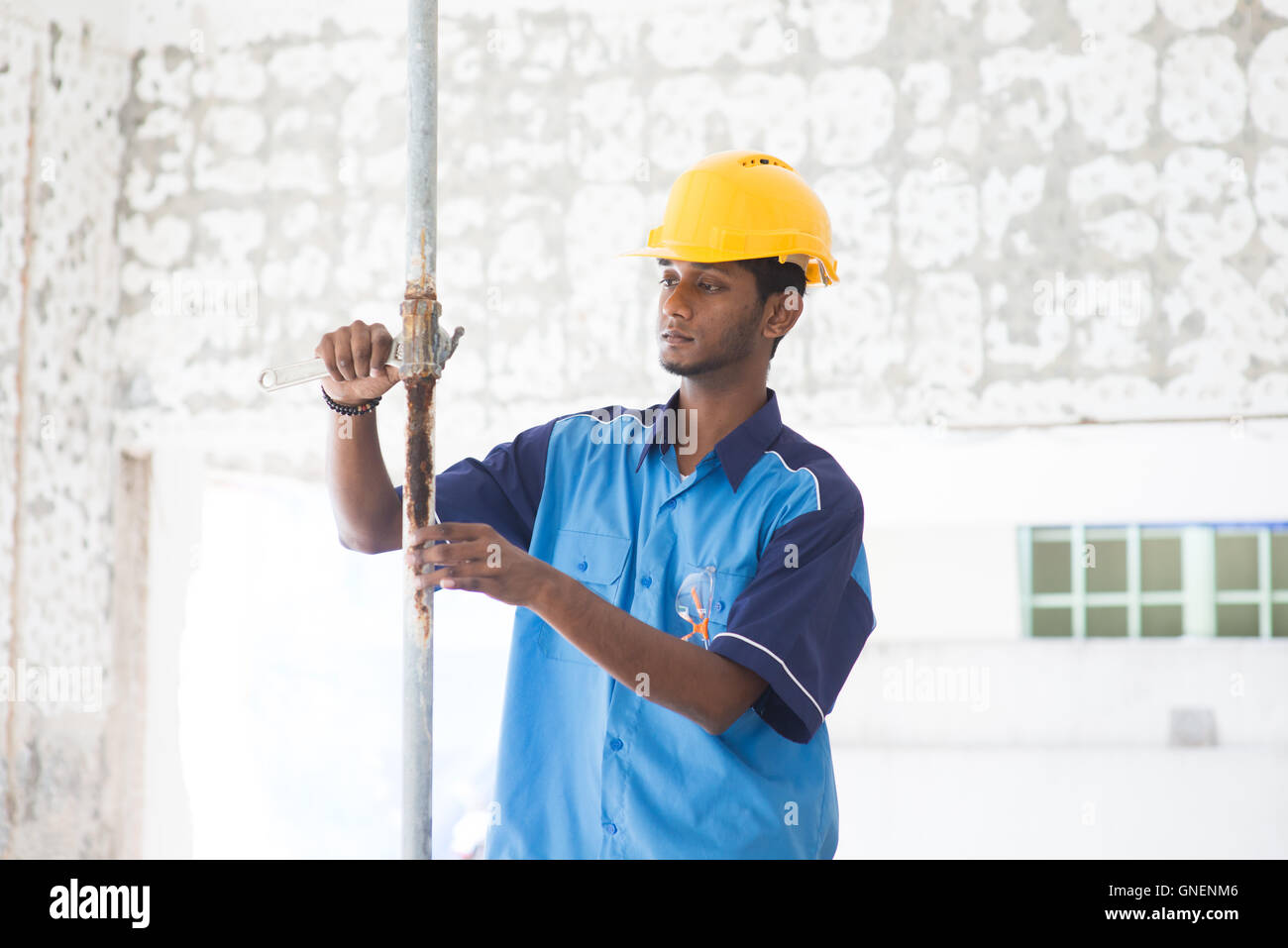 indian male plumber on site using hammer Stock Photo Alamy